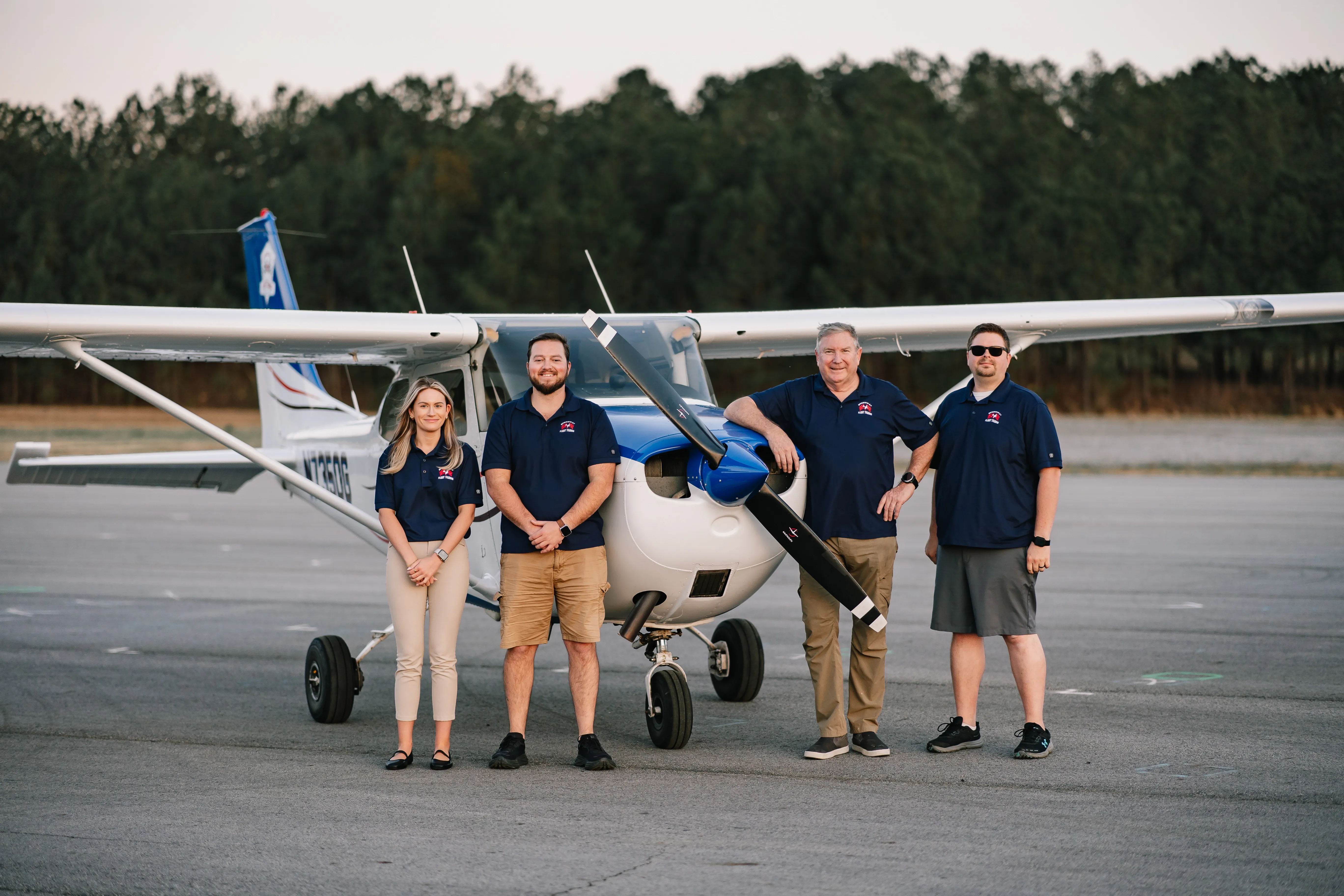 Speedway Flight Training instructors and staff in front of a Cessna at KHMP