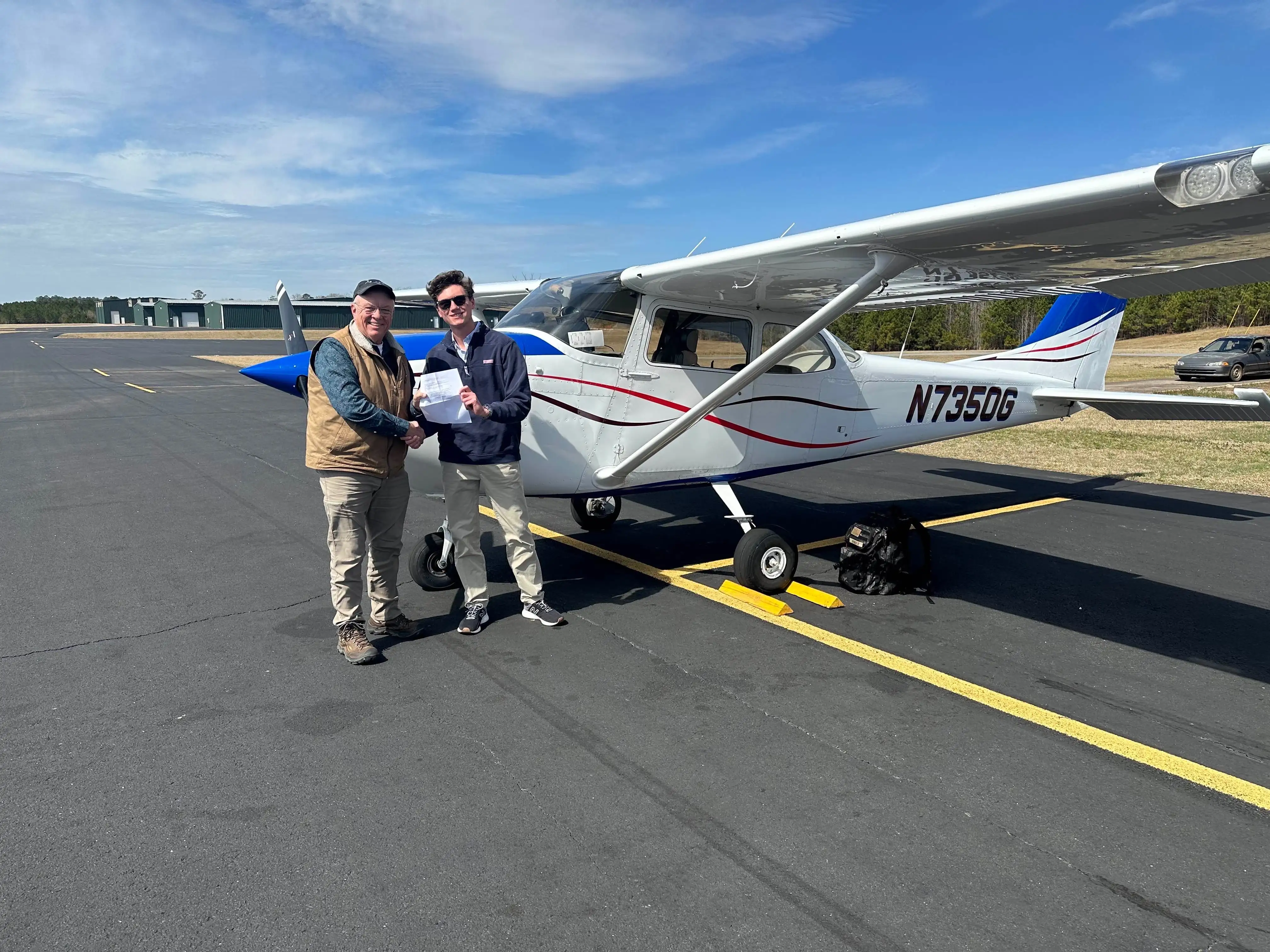 Speedway Flight Training instructor guiding a student pilot during pre-flight checks