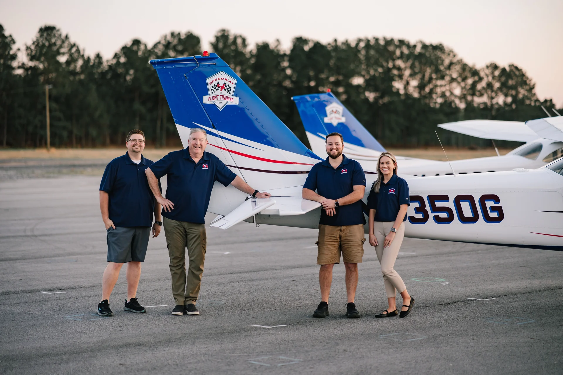 Speedway Flight Training team members standing in front of Cessna aircraft on the ramp
