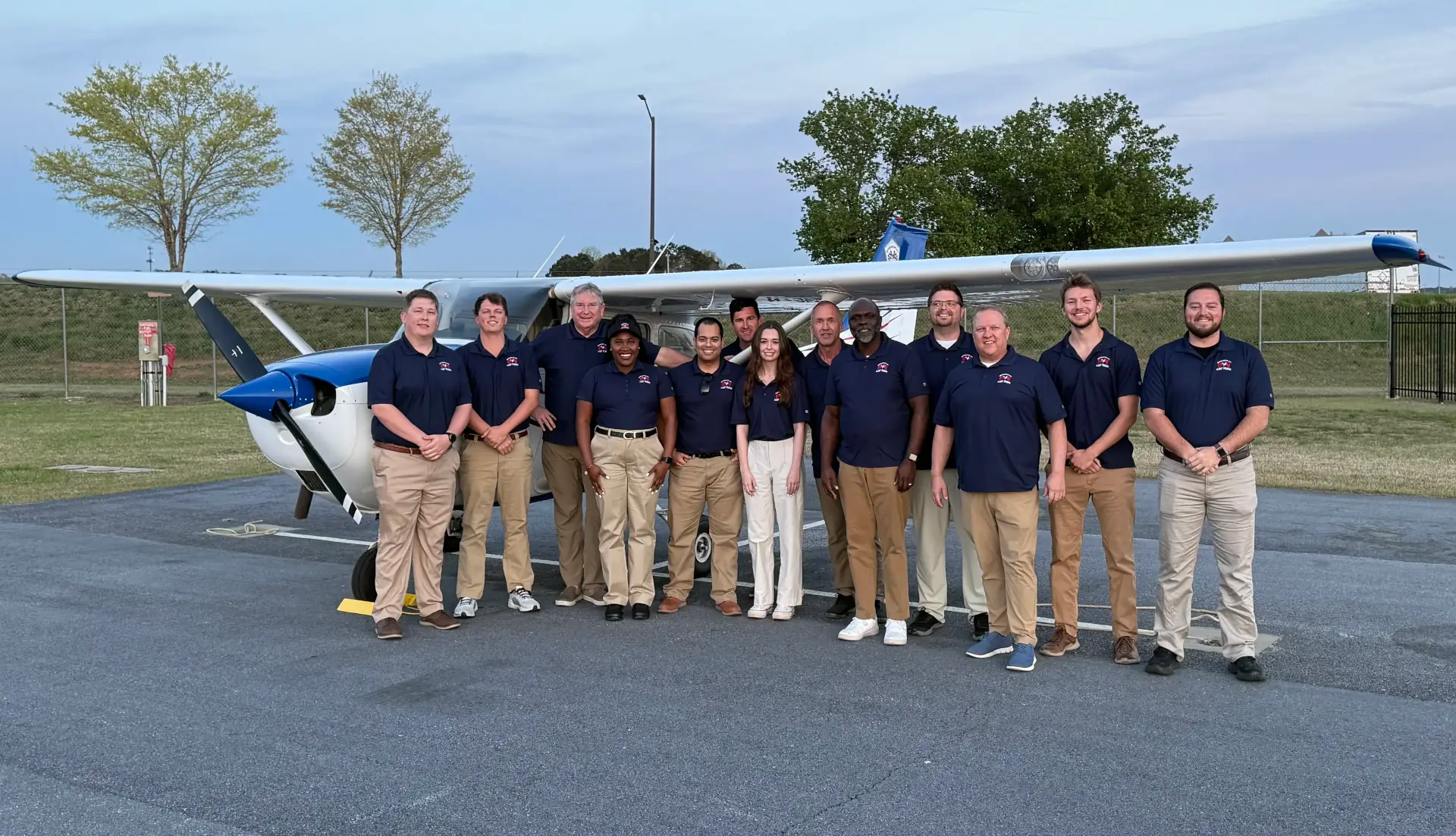 Speedway Flight Training team in front of an airplane